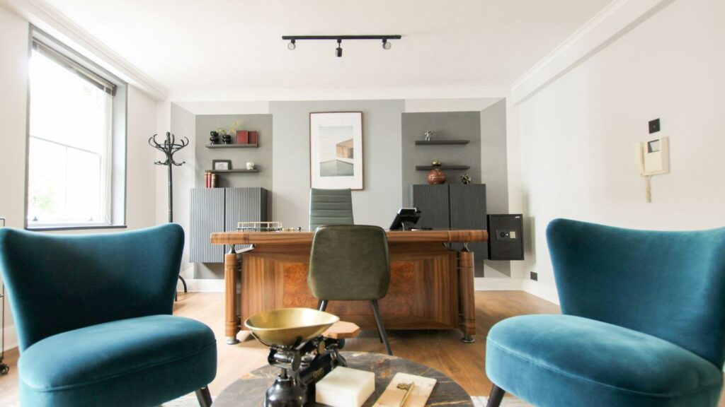 black and brown wooden table near blue padded chair
