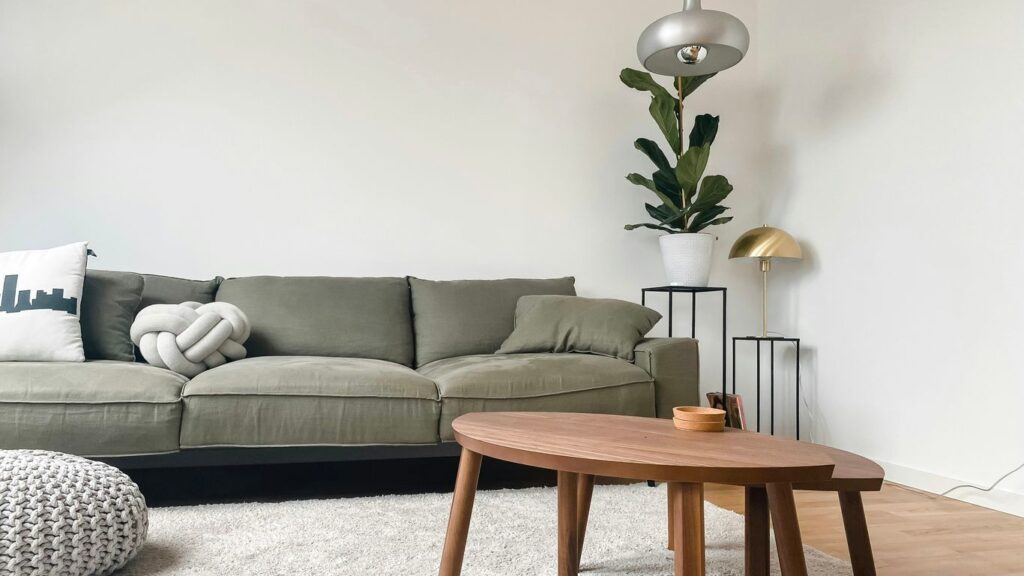 gray 2 seat sofa near brown wooden coffee table