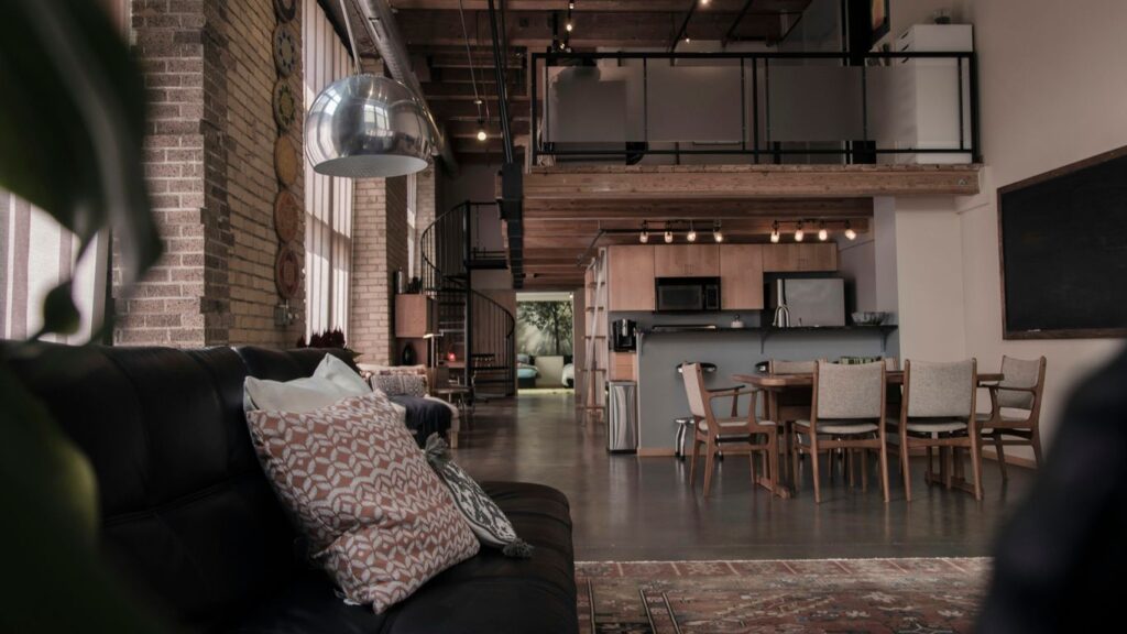 black leather couch with gray throw pillwo